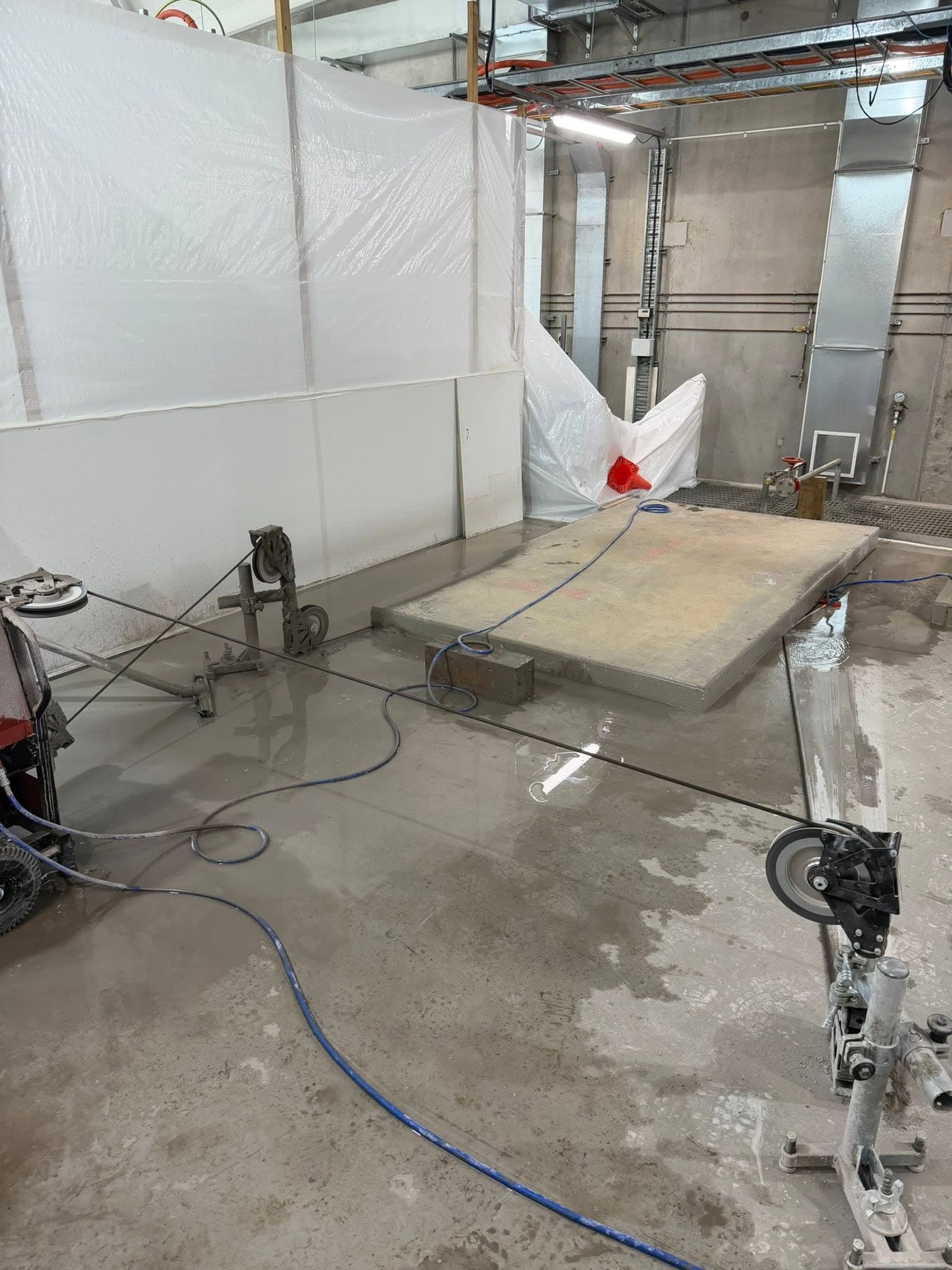 Wire saw pulleys and a cut concrete block on a Riverside Concrete Cutting job site